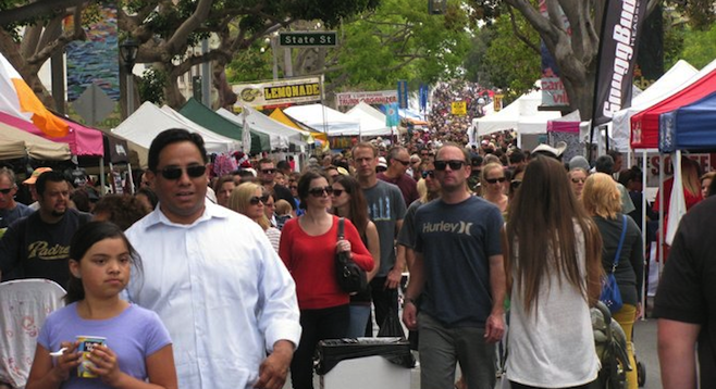 During what time of year is the Carlsbad Village Faire in California held?